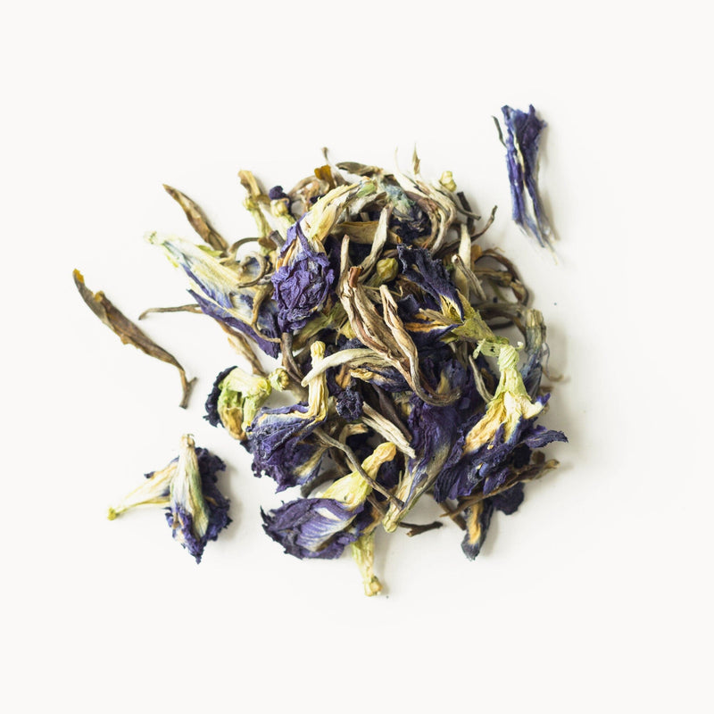 A pile of Blue Jasmine flowers from Rishi Tea & Botanicals on a white surface.