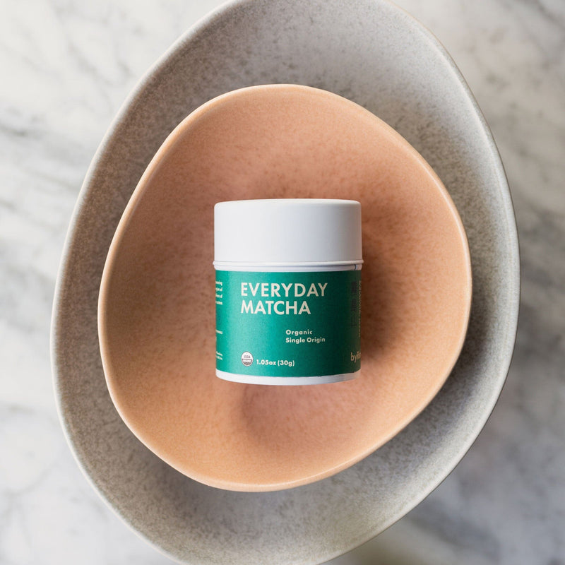 Everyday Matcha face cream in a bowl on a marble table. (Rishi Tea & Botanicals)