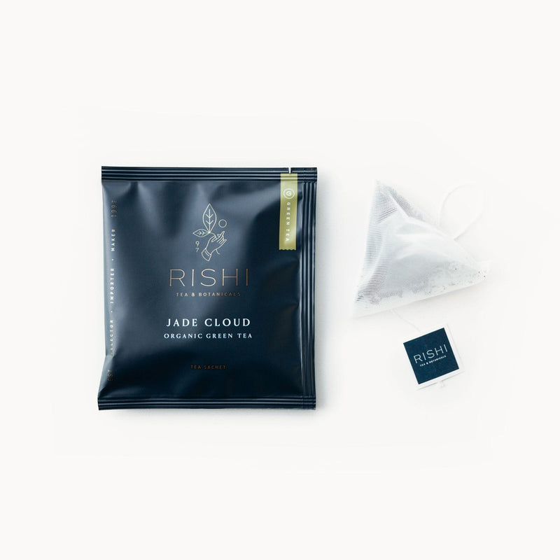 A bag of Jade Cloud tea with a Rishi Tea & Botanicals tea bag next to it.