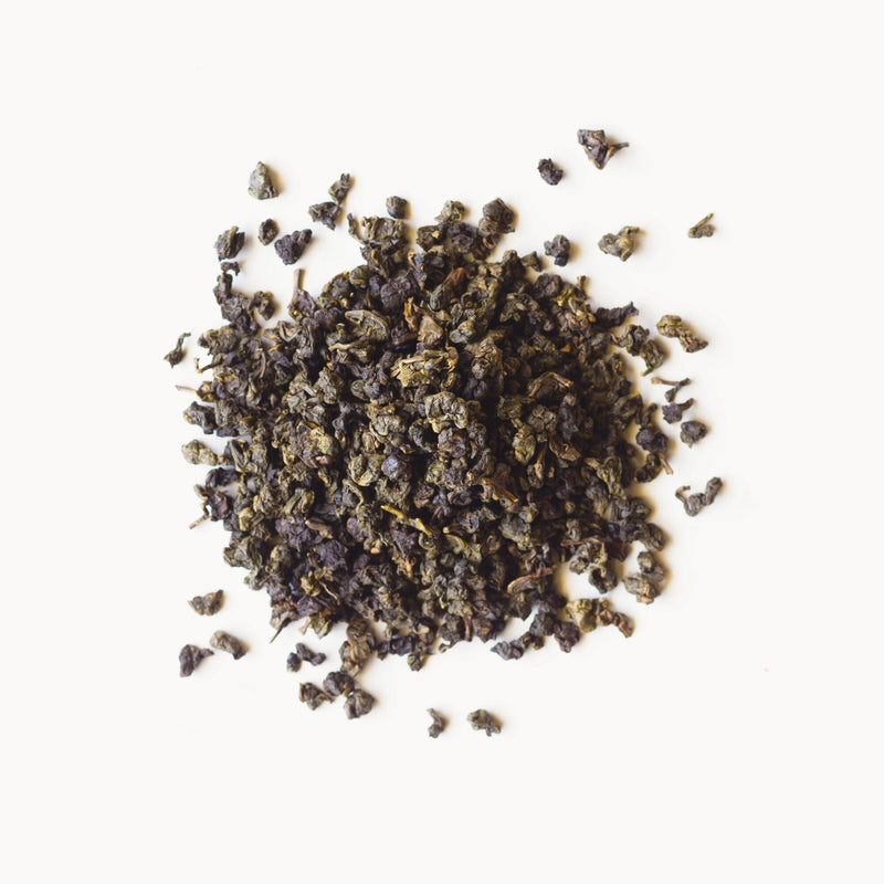 A pile of Iron Goddess of Mercy tea from Rishi Tea & Botanicals on a white background.