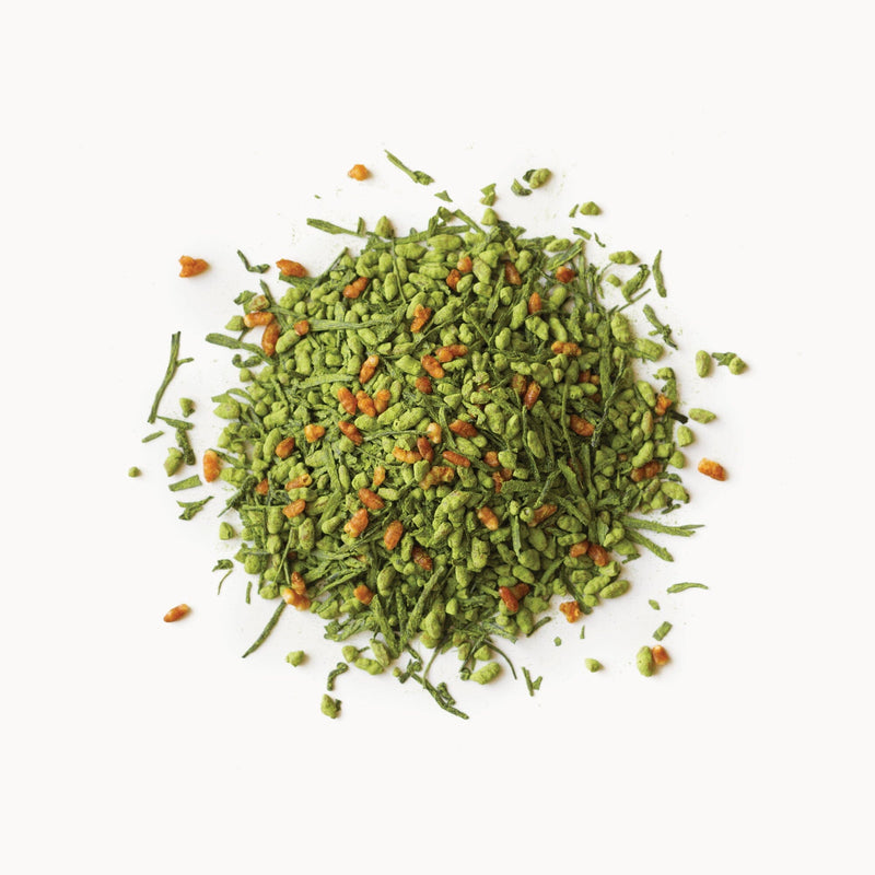 A pile of Matcha Genmaicha leaves on a white background by Rishi Tea & Botanicals.