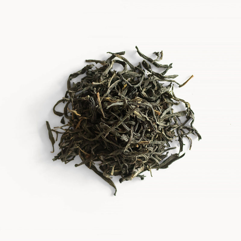 A pile of Jasmine Purple Buds tea on a white background, featuring rare purple leaf tea cultivar and Zi Juan, by Rishi Tea & Botanicals.